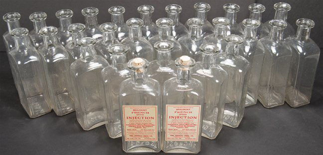 Quantity of Hy-Gloss Glass Product Bottles: Quantity of Hy-Gloss Glass Product Bottles. 29 bottles embossed on bottom. 7 inches tall.