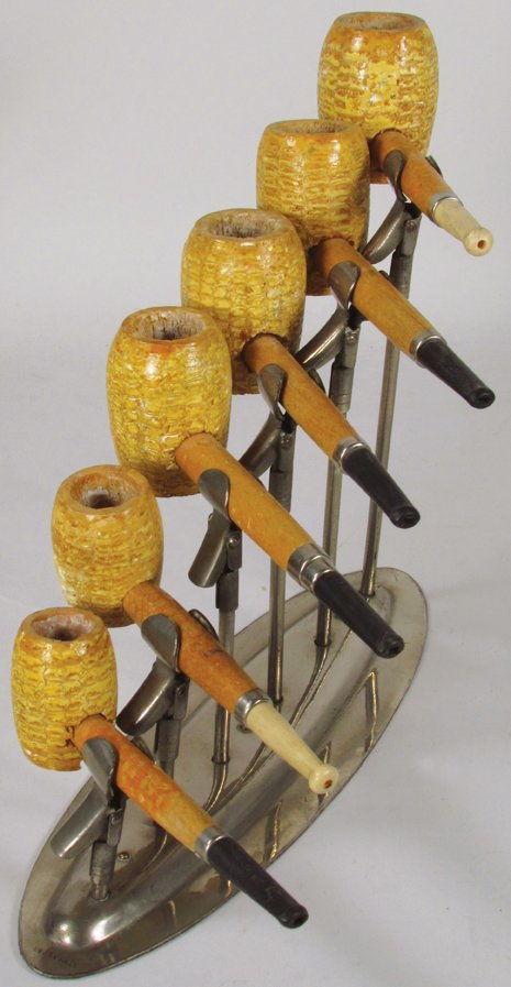 Nickel Plated Corn Cob Pipe Store Display: Nickel Plated Corn Cob Pipe Store Display. Pipes from the Missouri Meerschaum Co., all have original labels. Smallest pipe has damage at stem otherwise overall excellent original condition. 10 X 8 X 4