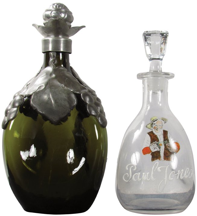 Two Pinch Style Bottles: Two Pinch Style Bottles. Paul Jones Whiskey enameled label with ground glass stopper, chips in stopper only. Olive green glass bottle with pewter metal overlay and stopper, no chips or cracks. Large b