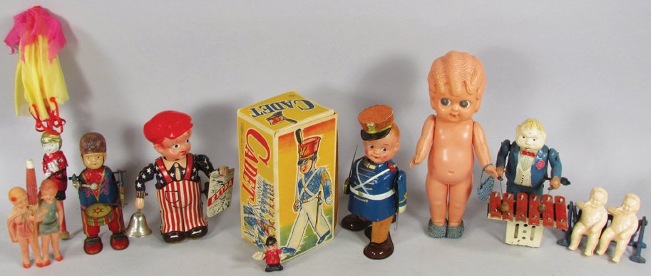 Collection of Early Celluloid Toys: Collection of Vintage Celluloid Toys. Mechanical Cadet in original box. Man playing xylophone mechanical toy, Newspaper boy and Drummer mechanical toys. Cupie, babies, policeman, sky diver and bathing