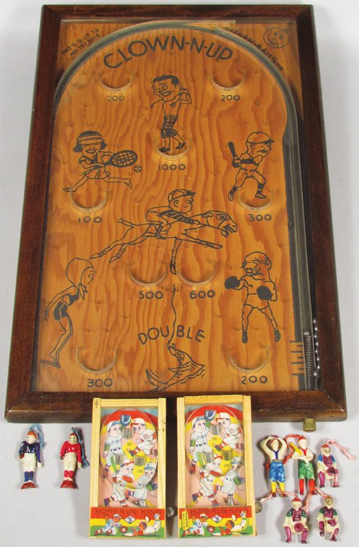 1933 Clown-Up Table Top Pinball Game: 1933 Clown-Up Table Top Pinball Game. Sports motif. Comes with (7) plastic sports key chain figures and (2) Homerun King Pocket Pinball games. Overall excellent condition. Clown-Up measures 11 1/2 X 1