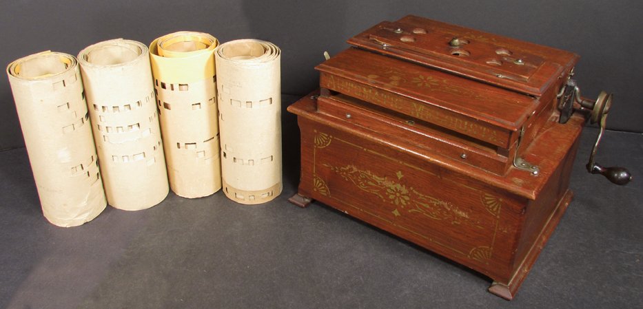 Antique Automatic Melodista Roller Organ Music Box: Antique Automatic Melodista Roller Organ Music Box. Original working condition, comes with four rolls. 11 1/2 X 8 3/4 X 9 1/2 inches.