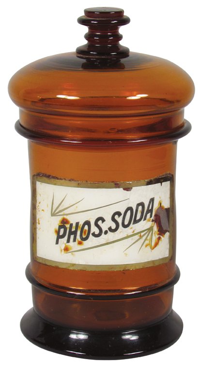 Label Under Glass Apothecary Jar: Phos. Soda Amber Apothecary Jar with label under glass. No chips or cracks, label has minor dislocation otherwise very good condition. 7 1/2 inches tall.