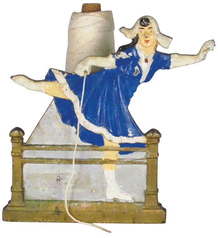 Cast Iron Dutch Skating Girl String Holder: Cast Iron Dutch Skating Girl String Holder by Judd Co. Flat backed, good original condition. 7 1/4 X 7 inches.