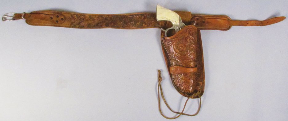 Hubley Champion Toy Cap Gun and Gun Rig: Hubley Champion Toy Cap Gun and Gun Rig. Tooled leather with "S" on holster strap. Gun in very good condition. Gun in excellent condition.