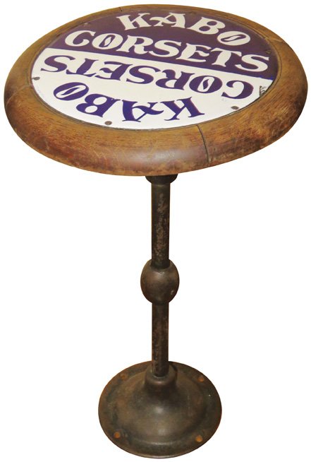Kabo Corsets Porcelain Advertising Stool: Kabo Corsets Porcelain, Wood and Cast Iron Stool. One chip otherwise excellent condition. 12 inch diameter X 22 inches tall