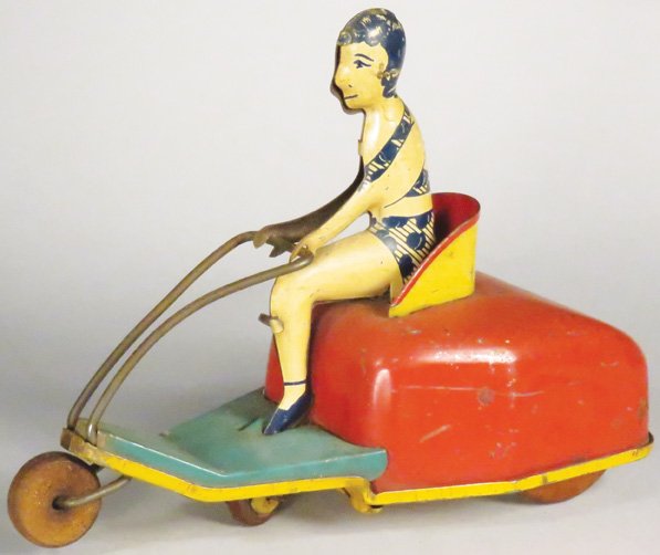 Bathing Beauty on Skooter Tin Wind Up Toy: Bathing Beauty on Skooter Tin Wind Up Toy. Made in USA. Scratches and age discoloration otherwise good condition. 6 3/4 inches long.