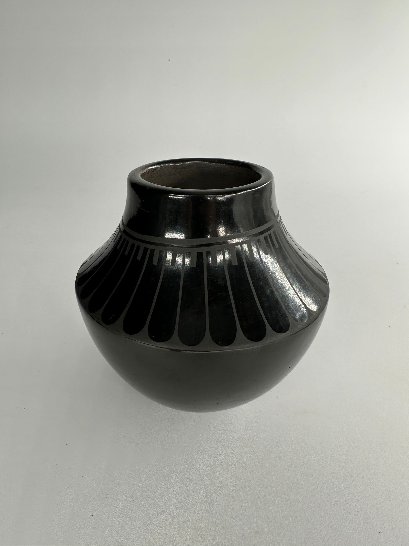 Black on black jar by Alice and Ruben Martinez: Black on black jar by Alice and Ruben Martinez of San Ildefonso Pueblo. Alice Martinez, a distinguished potter from San Ildefonso Pueblo, has upheld her family's ceramic traditions for over five decad