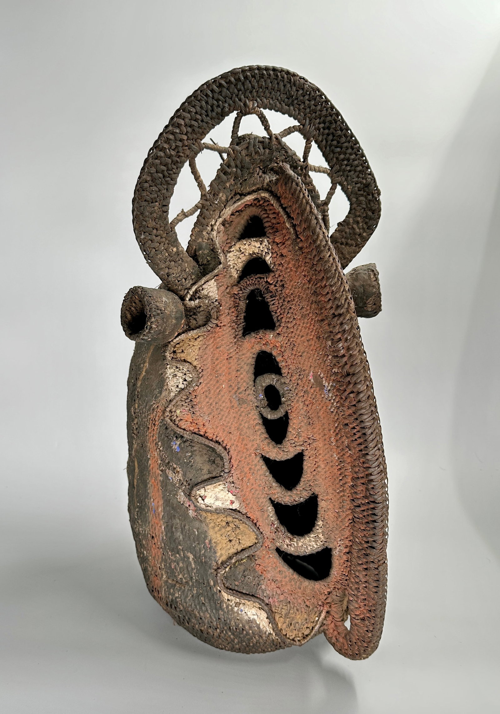 Huge beautifully painted woven yam mask: Mid-20th century Papua New Guinea Yam Mask. Yes, it is a mask for a vegetables. Also an important cultural symbol. A striking hand-woven vegetal fiber mask of tall form, painted in vivid hues of russe