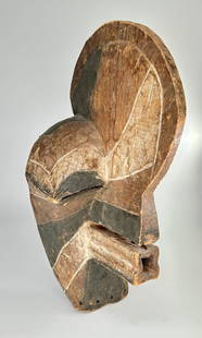 Songye Kifwebe mask: Dramatic male Kifwebe mask, Songye peoples, Congo. Wood, pigment, remnants of hair. The incised and whitened striations on this aggressive male mask enhance its sculptural power. This type of mask is