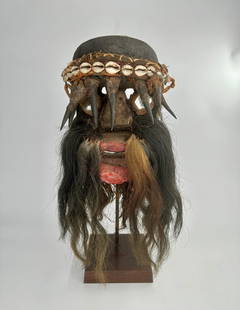 Ivory Coast Gere mask: West Africa, Ivory Coast, Gere peoples, ca. mid-20th century CE. A carved wooden face mask with a pair of petite eye holes drilled above the bulbous nose. The "eyes" are comprised of mirrored glass fr