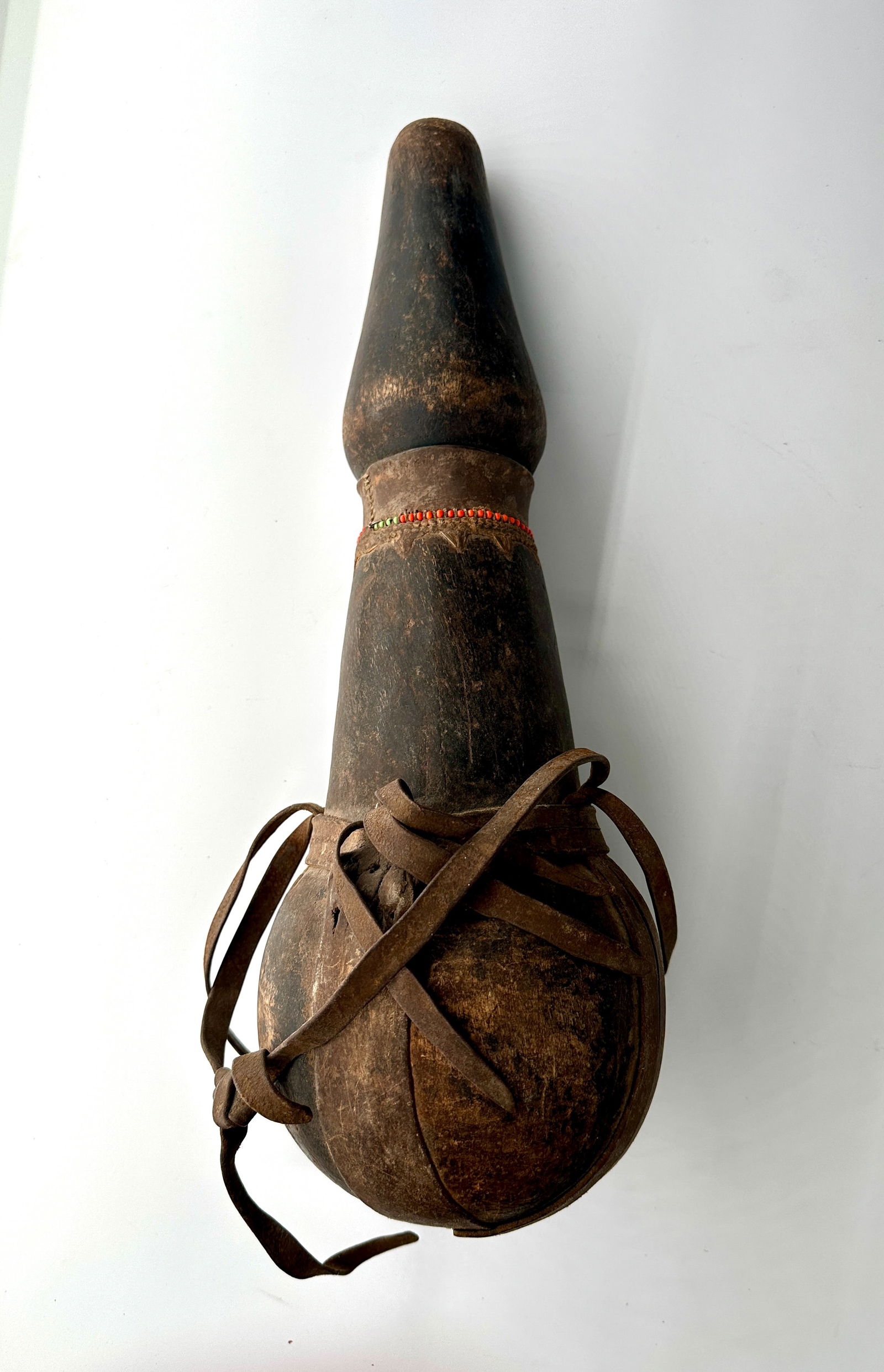 Rendille or Samburu Container (ililip or mila Samburu) with lid, Kenya.: Rendille or Samburu Container (ililip or mila Samburu) with lid. In very good condition decorated with leather straps and beads. Excellent form. 17.5 x 5.5 inches. The general form of these containers