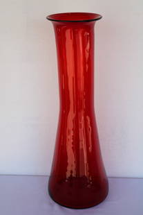 Blenko Red Glass Vessel by Wayne Husted: Hand blown red glass vessel/vase by Wayne Husted for Blenko. Vase measures 26.5" high, 7" diameter (top) and 9.5" diameter (bottom). Manufactured by Blenko, USA. Blenko Glass Company is an art glass c