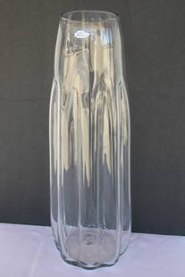 Blenko Clear Vessel with Label.: Hand blown clear vessel with label by Blenko. Vase measures 22.75" high, 4.75" diameter at top and 7.5" diameter at bottom. Manufactured by Blenko, USA. Blenko Glass Company is an art glass company th
