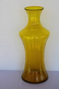 Blenko Yellow Vessel, 2006: Blenko hand blown yellow vessel etched Blenko and dated 2006. Vessel measures 22.25" high, 5.5" diameter on top and 9" bottom. Manufactured by Blenko, USA. Blenko Glass Company is an art glass company
