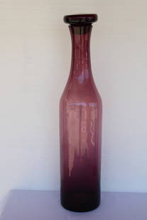 Blenko Amethyst Vessel with Stopper by Wayne Husted: Architectural decorative hand blown bottle by Blenko with stopper by Wayne Husted. Vessel measures 31.75" high, 4" diameter on top and 7" bottom. Stopper is 5.5" diameter and 3.25" high. Bottle with s