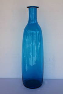 Turquoise Vessel by Blenko: Blenko hand blown turquoise vessel. Vessel measures 28.75" high, 4" diameter on top and 8" in mide section. Manufactured by Blenko, USA. Blenko Glass Company is an art glass company that began produci