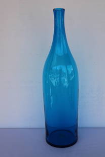 Turquoise Vessel by Blenko: Blenko hand blown turquoise vessel. Vessel measures 25" high, 2" diameter on top and 6.25" on bottom. Manufactured by Blenko, USA. Blenko Glass Company is an art glass company that began producing in
