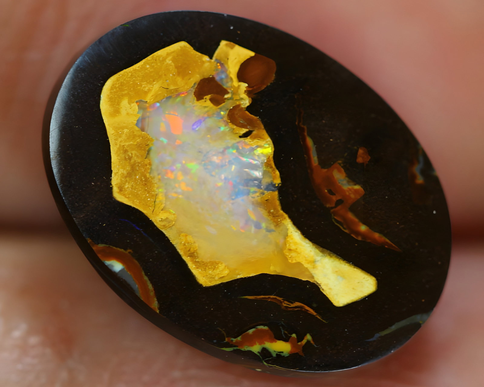 7.56 Carat Boulder Opal from Koroit Queensland: This auction lot of 7.56 carat boulder opal from Koroit Queensland, measuring 15.4x11.3x4.1mm, exemplifies the masterful craftsmanship and rich cultural heritage of Australian opals. Boulder opals wer