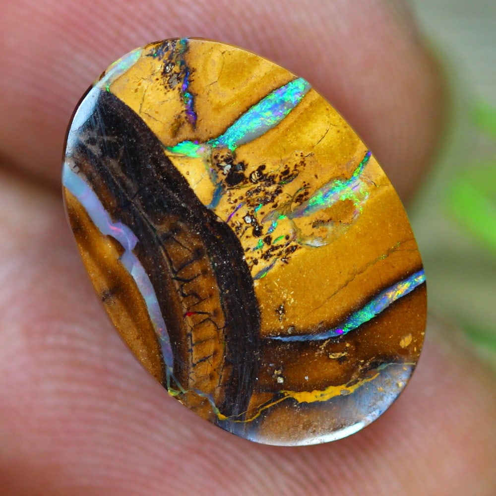 6.7 Carat Boulder Opal from Koroit Queensland: This auction lot of 6.7 carat boulder opal from Koroit Queensland, measuring 17.2x12.3x3.6mm, exemplifies the remarkable craftsmanship and rich cultural significance attributed to Australian opals. Bo