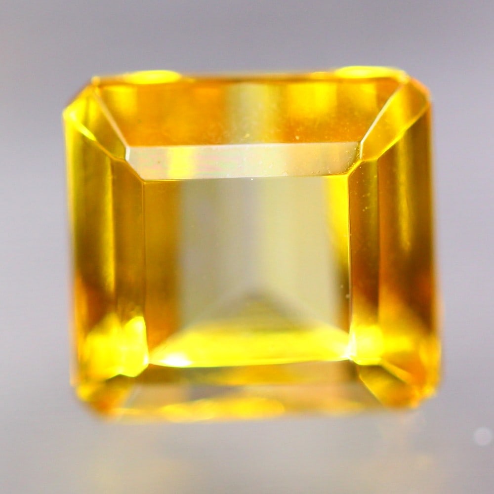 Exquisite 10.8 Carat Brazilian Yellow Topaz Gemstone: Auction lot of 10.8-carat Brazilian Yellow Topaz, measuring 10.7x10.2x8.8mm. Birthstone for November and is often used in rings, pendants, and earrings. It is traditionally gifted for the 4th wedding 