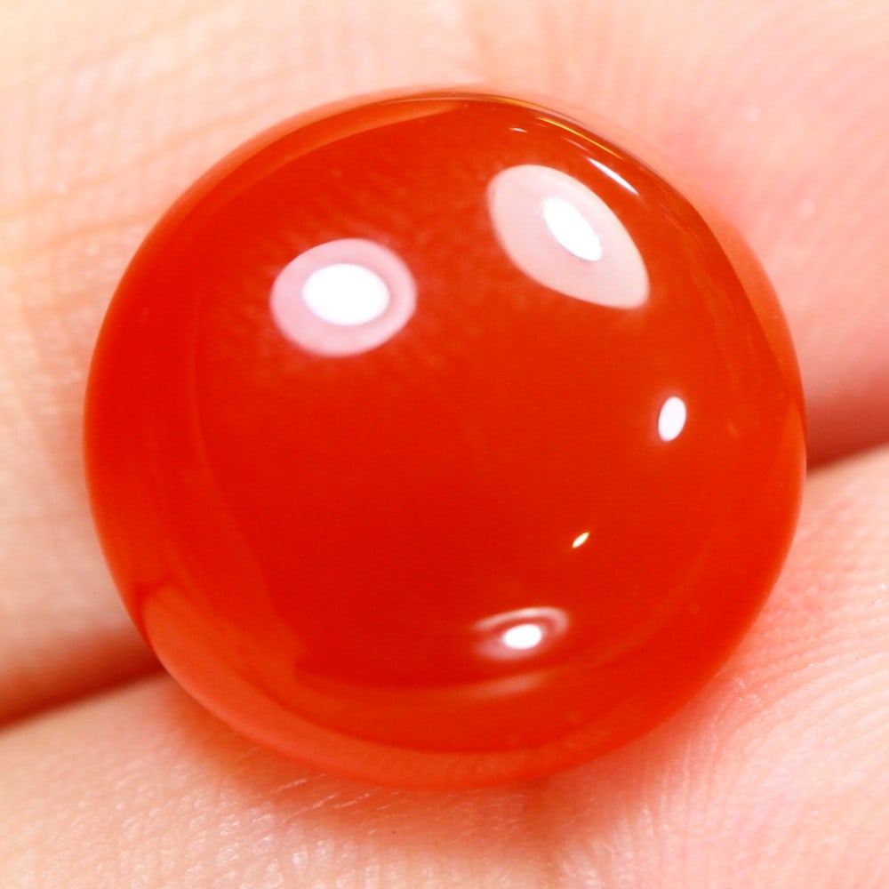Radiant 11.85 Carat Brazilian Orange Onyx: Auction lot of 11.85 carat Brazilian Orange Onyx, measuring 15.0x15.0x6.7mm. It is often used in rings, pendants, and earrings. It is traditionally gifted for the 4th wedding anniversary and is a symb