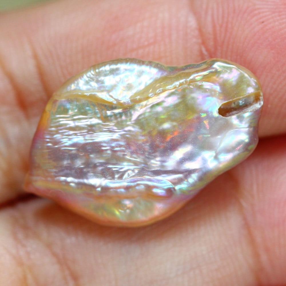 Exquisite 11.39 Carat Cultured Keshi Pearl: Auction lot of 11.39 carat Cultured Keshi Pearl, measuring 24.5x15.9x5.2mm. Birthstone for June and is often used in necklaces, earrings, and bracelets. It is traditionally gifted for the 3rd wedding 