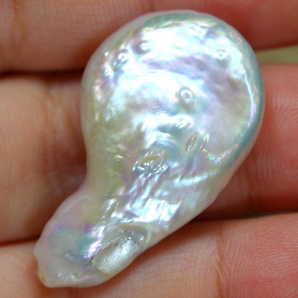 Exquisite 25.90 Carat Cultured Keshi Pearl: Auction lot of 25.90 carat Cultured Keshi Pearl, measuring 34.9x20.5x7.2mm. Birthstone for June and is often used in necklaces, earrings, and bracelets. It is traditionally gifted for the 3rd wedding 