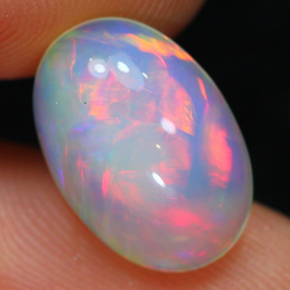 Ethiopian 4.83 Carat Welo Opal - Mesmerizing Fire and Brilliance: Auction lot of 4.83 carat Ethiopian Welo Opal, measuring 15.5x10.7x5.9mm. Birthstone for October and is often used in rings, pendants, and earrings. It is traditionally gifted for the 14th wedding ann