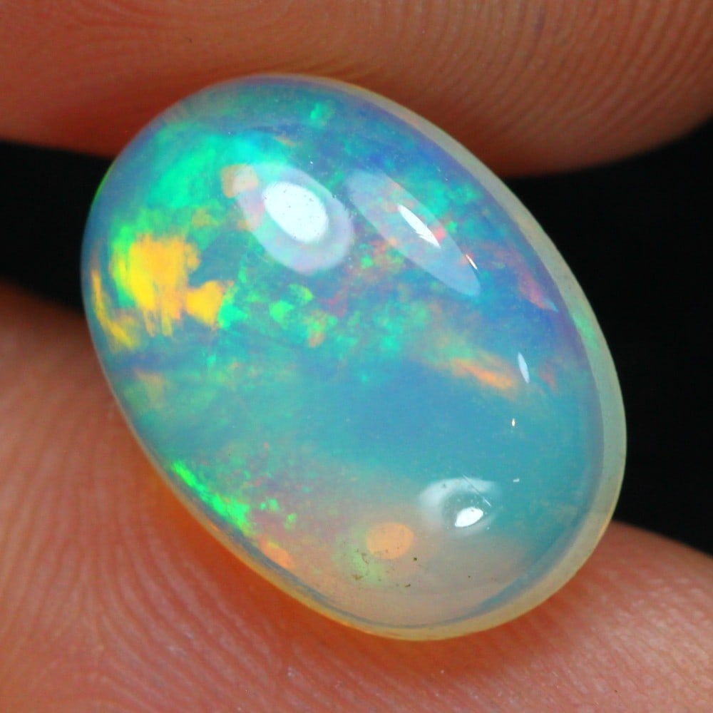 Ethiopian 3.42 Carat Welo Opal - Mesmerizing Fire and Brilliance: Auction lot of 3.42 carat Ethiopian Welo Opal, measuring 14.0x10.2x5.6mm. Birthstone for October and is often used in rings, pendants, and earrings. It is traditionally gifted for the 14th wedding ann
