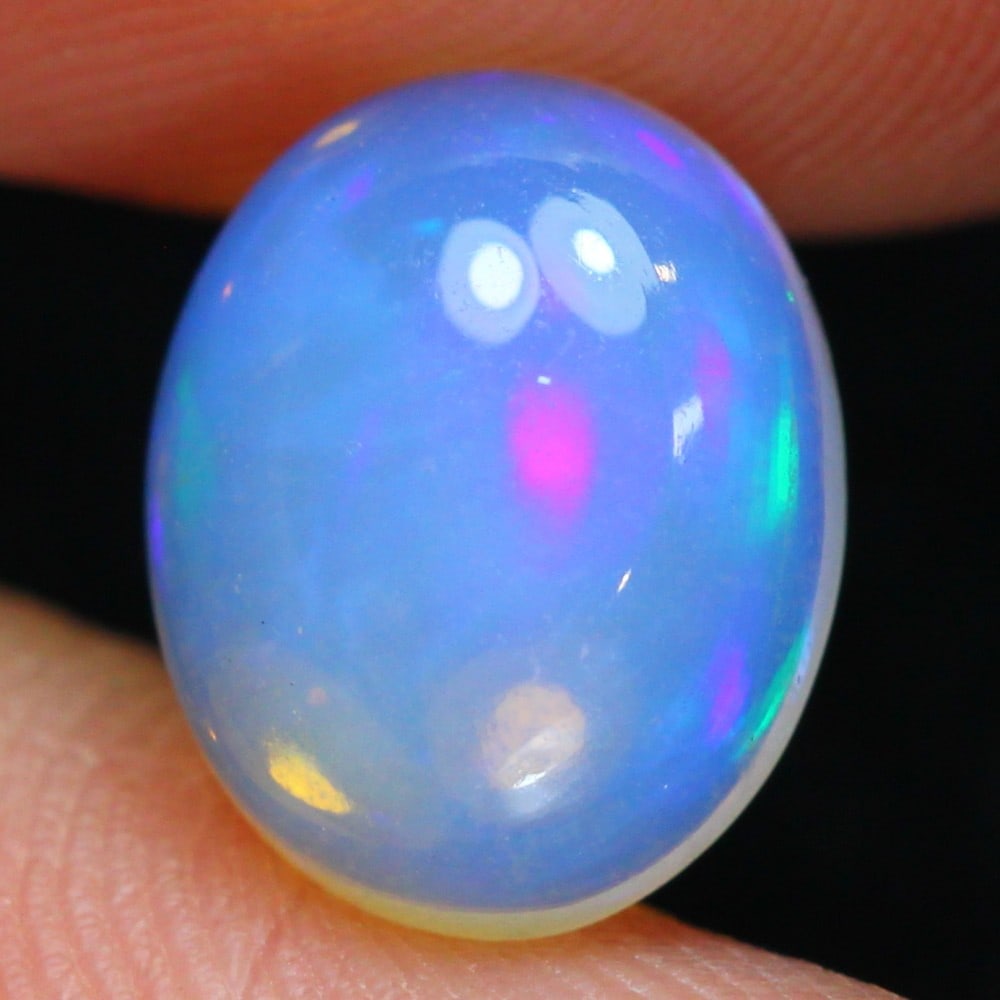 Ethiopian 2.27 Carat Welo Opal - Mesmerizing Fire and Brilliance: Auction lot of 2.27-carat Ethiopian Welo Opal, measuring 16.2x14.1x9.4mm. Birthstone for October and is often used in rings, pendants, and earrings. It is traditionally gifted for the 14th wedding ann