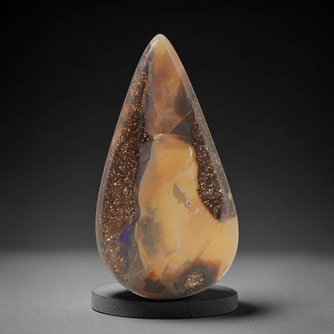 7.60 Carats Bicolor Boulder Opal Teardrop Cabochon - Natural Australian Stone, 17XC: This striking boulder opal cabochon, measuring 25.3 x 13.5 x 3.3 mm, presents a dramatic split composition. Polished into an elegant teardrop shape, one side features soft honey-yellow opal with subtl