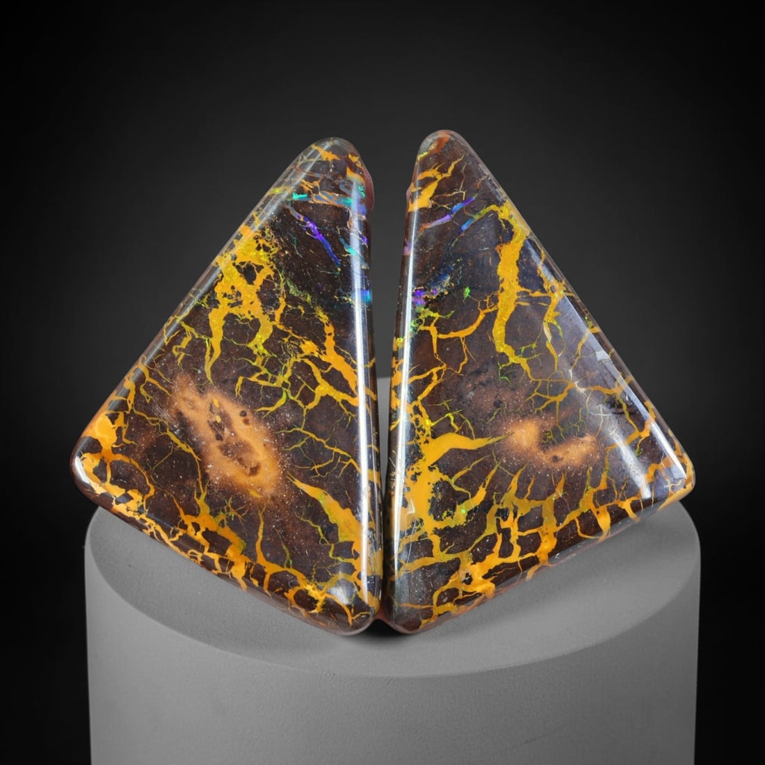 77.07ct Pair Natural Australian Queensland Matrix Boulder Opal Cabochons, 80AT: Matched pair of hand-polished freeform triangular cabochons sourced from Queensland matrix boulder opal, each piece built upon dark ironstone host rock threaded with sprawling branching golden opal ve
