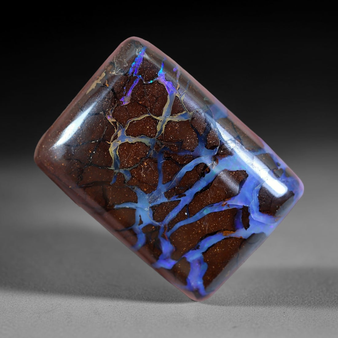 34.46ct Natural Australian Queensland Matrix Boulder Opal Cabochon, 11AV: Hand polished rounded rectangular cushion cabochon crafted from natural Queensland matrix boulder opal, featuring speckled warm brown ironstone host matrix interlaced with broad branching opal veins b
