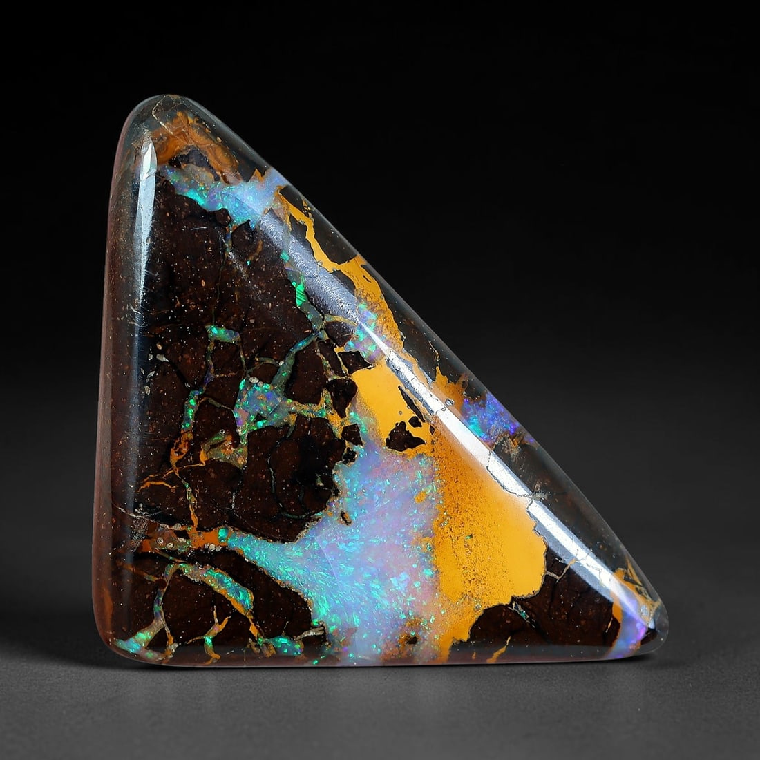8.9ct Natural Australian Queensland Matrix Boulder Opal Triangular Cabochon, 45AV: Hand polished smooth freeform triangle cabochon crafted from natural Queensland matrix boulder opal, featuring deep dark speckled ironstone matrix contrasted by expansive swathes of vivid golden-orang