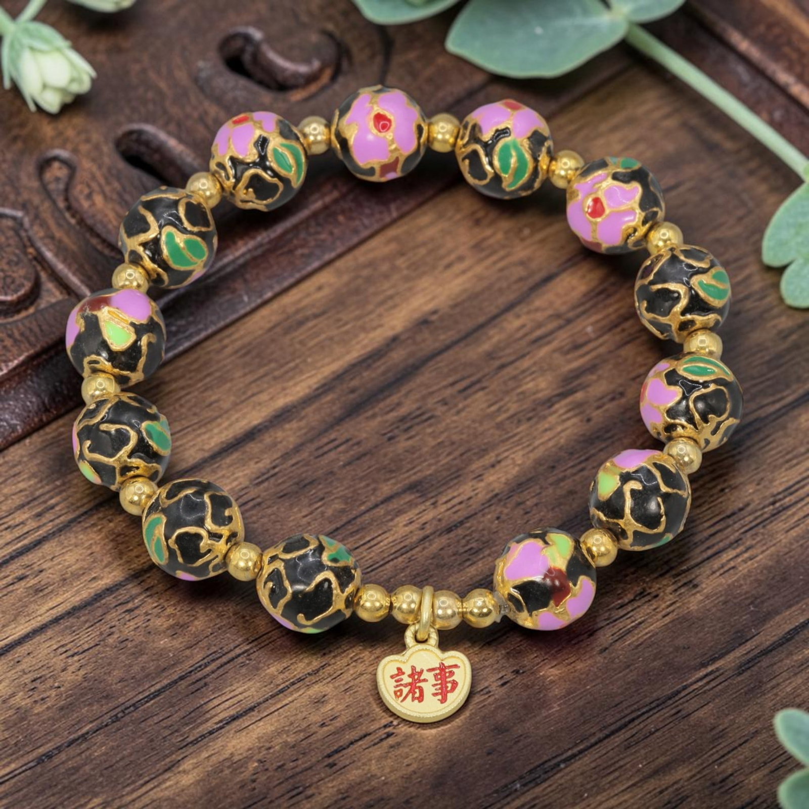 A Chinese Cloisonne Enamel Beaded Bracelet - Black Gold-Tone "All Things" Charm, 31YJ: This modern Chinese-style bracelet features 10.32mm round cloisonne enamel beads in a deep black hue, each detailed with raised gold-tone outlines framing pink floral motifs accented with green and re