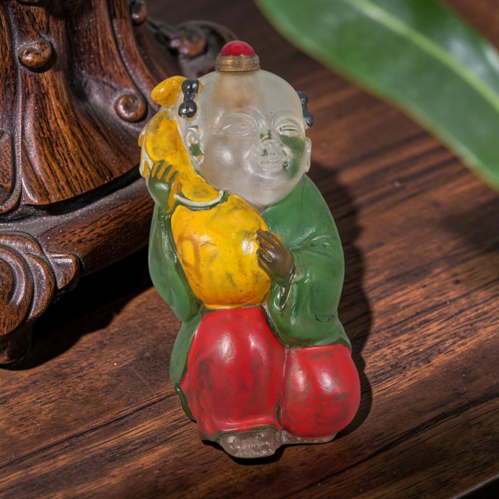 Vintage Chinese Hand Painted Clear Liuli Glass Snuff Bottle, 55AS: This fully sculpted anthropomorphic snuff bottle is molded from translucent frosted clear vintage Chinese liuli glass, shaped as a plump kneeling traditional Chinese child figure with peacefully close