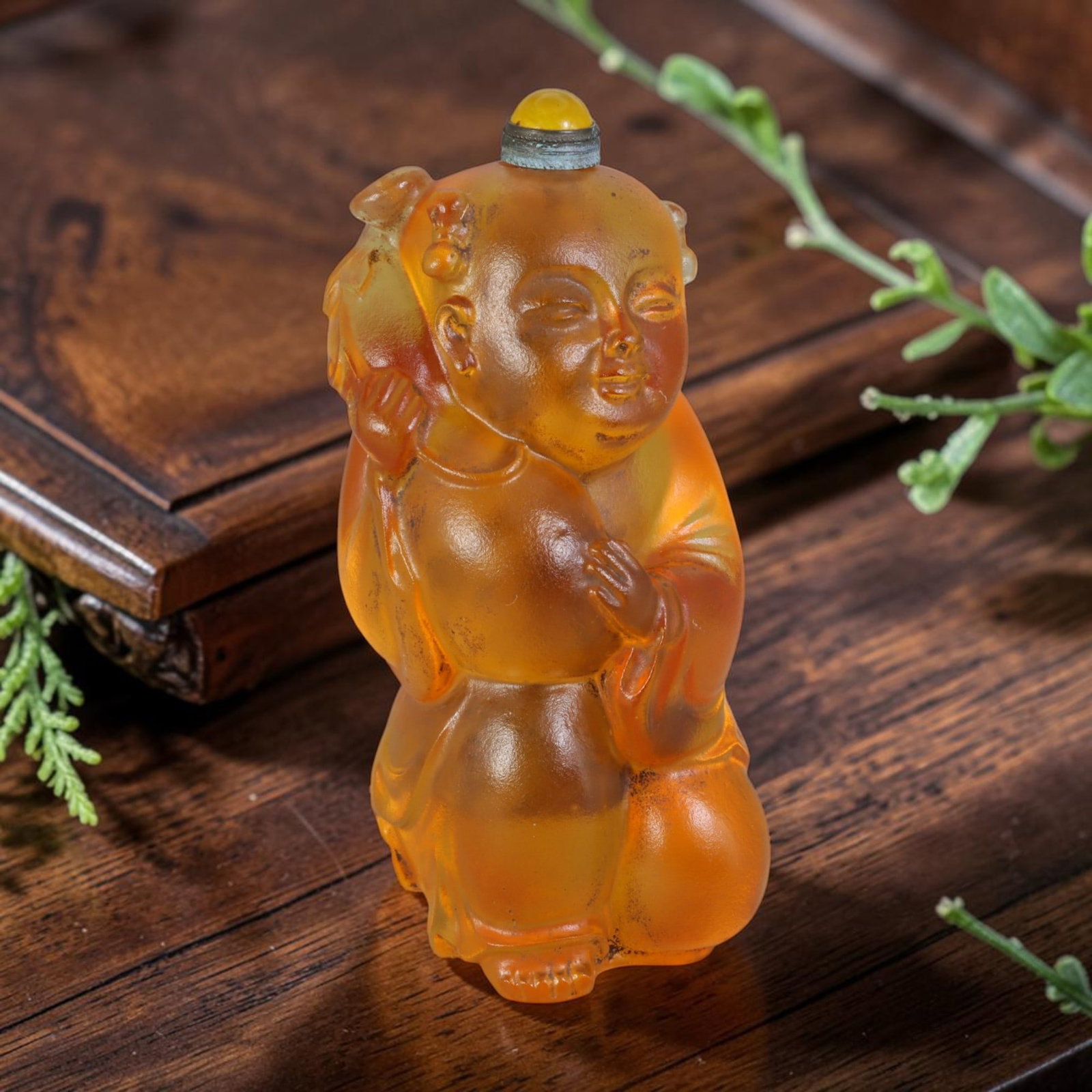 Vintage Chinese Honey Amber Liuli Glass Snuff Bottle - Kneeling Child Longevity Peach Figurine, 51AS: This fully sculpted anthropomorphic snuff bottle is crafted from translucent frosted honey-amber vintage Chinese liuli glass, shaped as a plump kneeling traditional Chinese child figure with delicate 