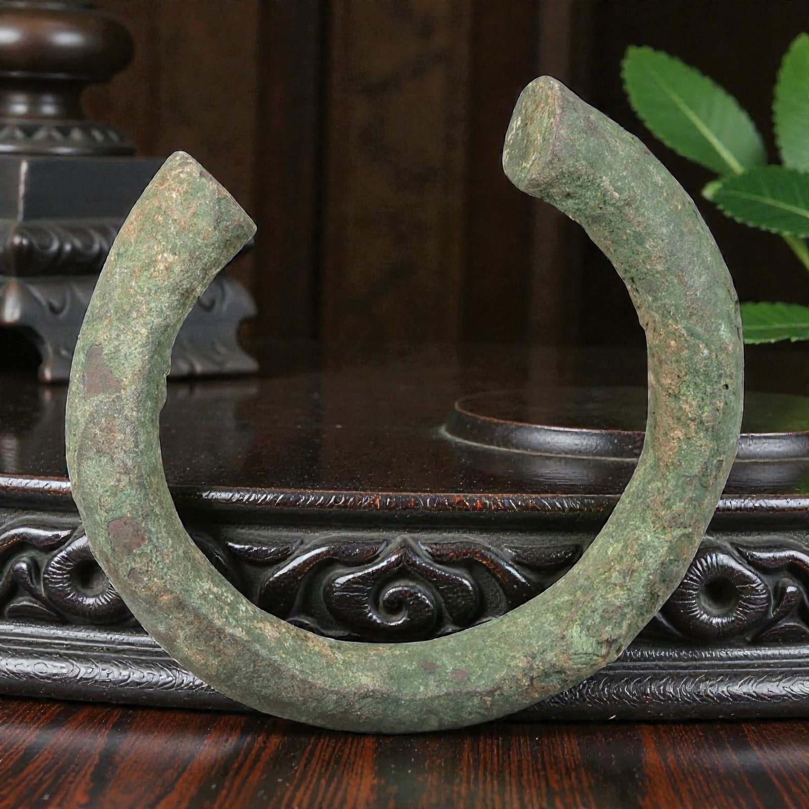 Ancient Roman Bronze Bracelet - Open Bangle Form, 34BN: Crafted from bronze, this open bracelet is formed as a thick, rounded rod creating a horseshoe-shaped cuff with a narrow gap between the flat terminals. The surface displays a heavily textured, uneven