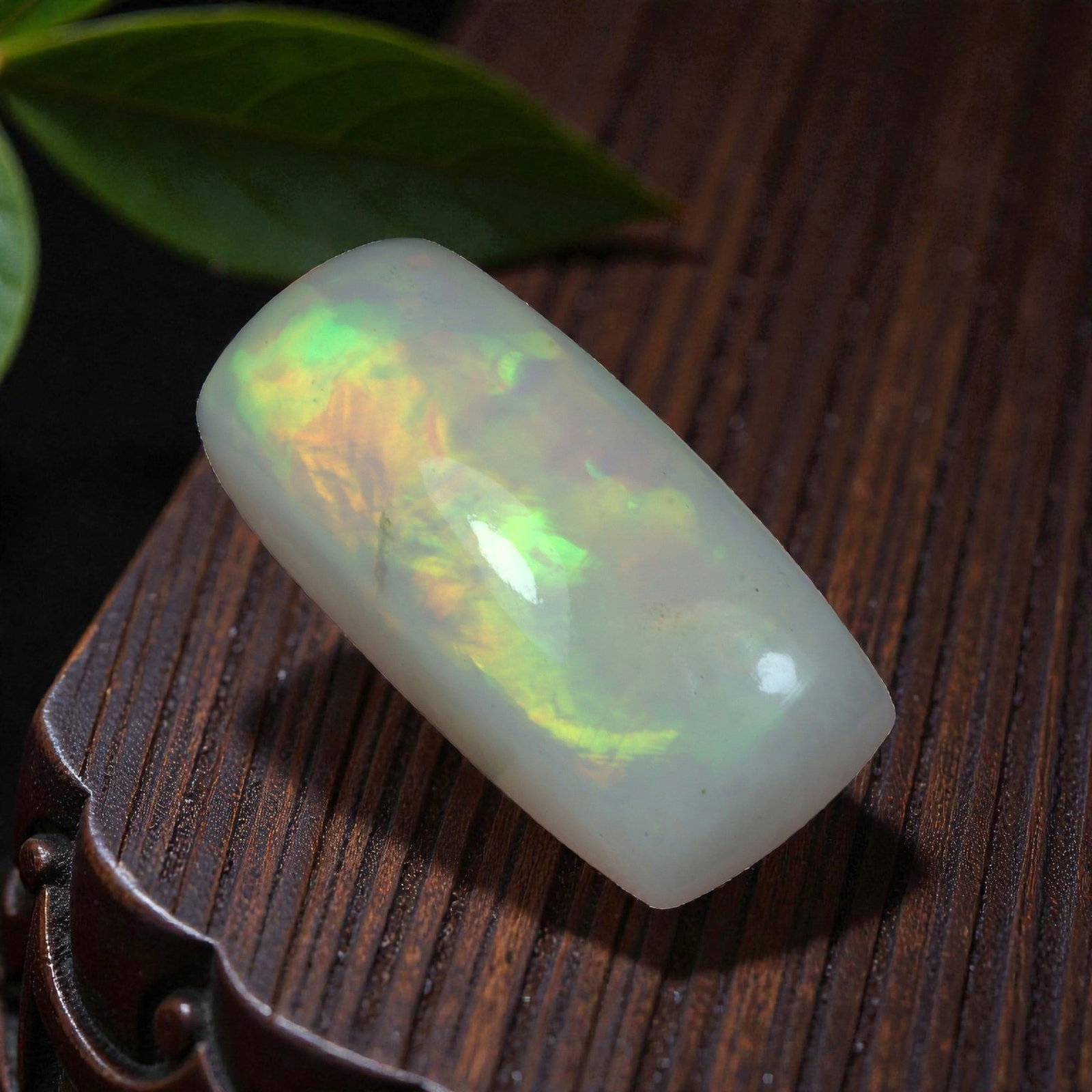 7.45 Carats Welo Opal Elongated Cushion Cabochon - Natural Ethiopian Stone, 10XB: This striking elongated cushion cabochon of Welo opal captivates with a vivid, shifting play of color, dominated by sweeping flashes of lime green and golden yellow, accented by subtle hints of fiery 