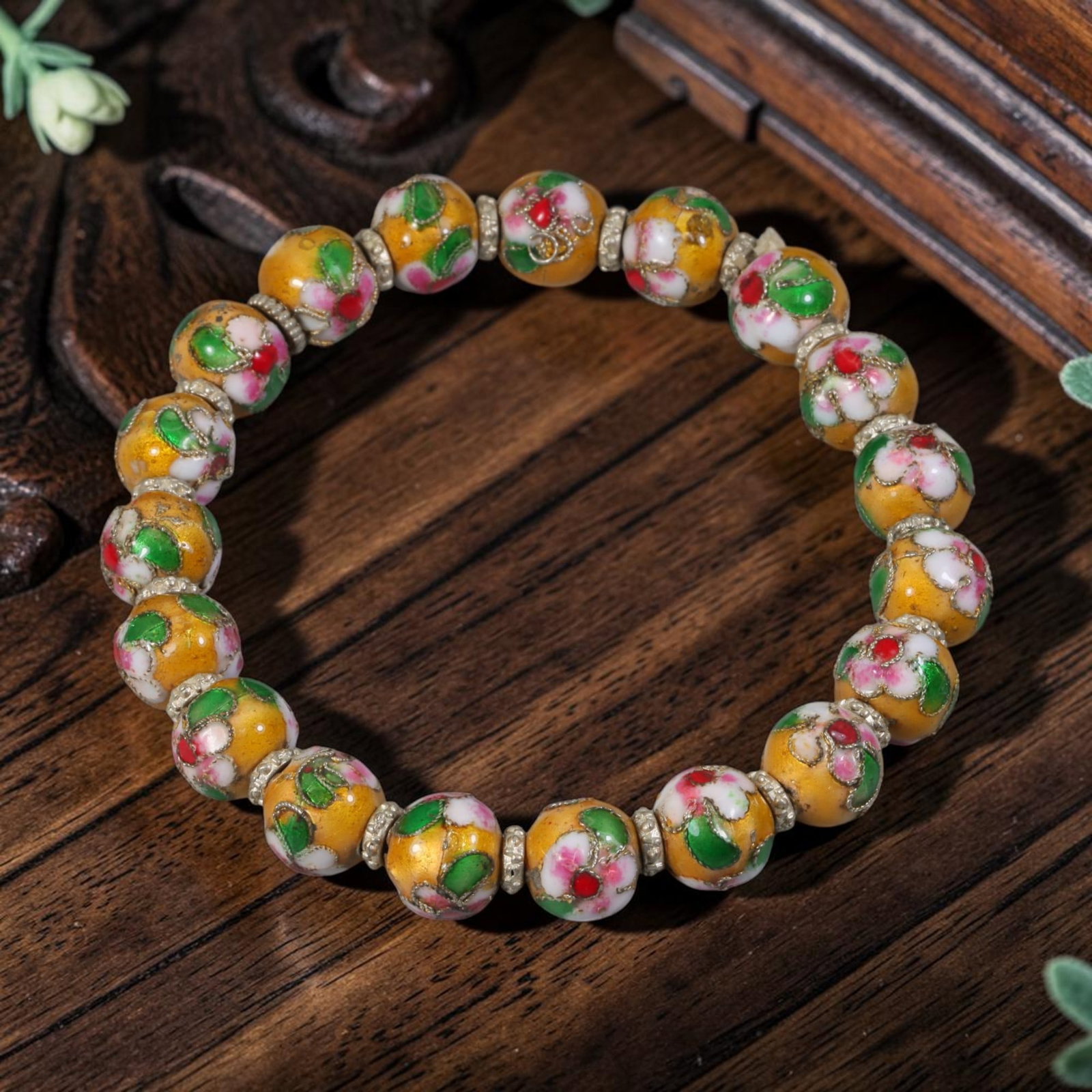 A Chinese Vintage Yellow Cloisonne Floral Beaded Bracelet, 5YM: This classic Chinese-style stretch bracelet features 9.8mm round cloisonne enamel beads in a warm yellow hue, each hand-decorated with delicate floral motifs in pink, green, white, and red, outlined w