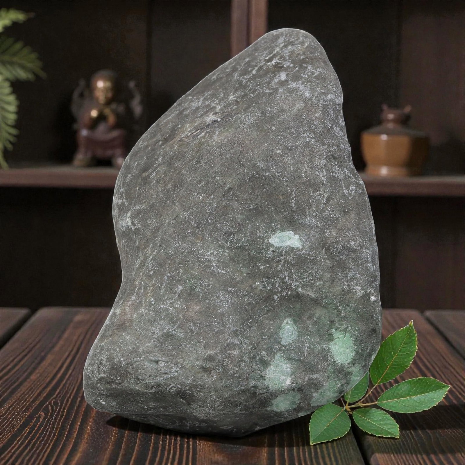 1185Ct Natural Type A Burmese Jadeite Jade Rough Stone - Green Raw Material, 2ZB: Natural Type A Burmese jadeite rough stone, retaining its thick, naturally weathered grey outer skin with subtle green mineral deposits visible along the lower edge. The stone maintains its uncut, nat