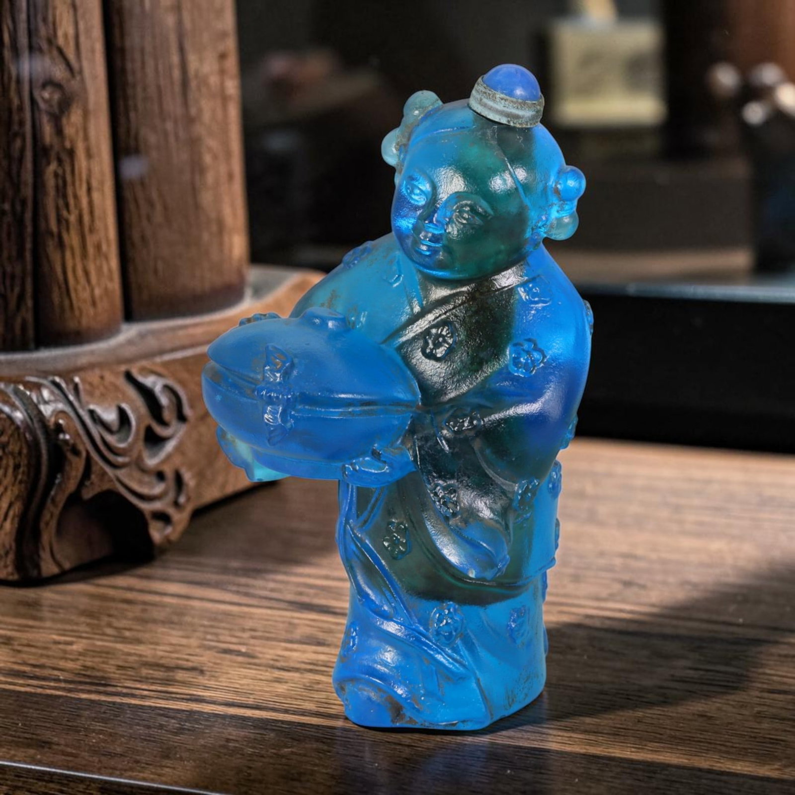 Vintage Chinese Liuli Glass Snuff Bottle - Carved Girl Holding Lidded Box Figurine Vessel, 34AS: This fully sculpted anthropomorphic snuff bottle is molded from translucent rich sky-blue frosted vintage Chinese liuli glass, shaped as a traditional young girl figure decorated with twin rounded hai