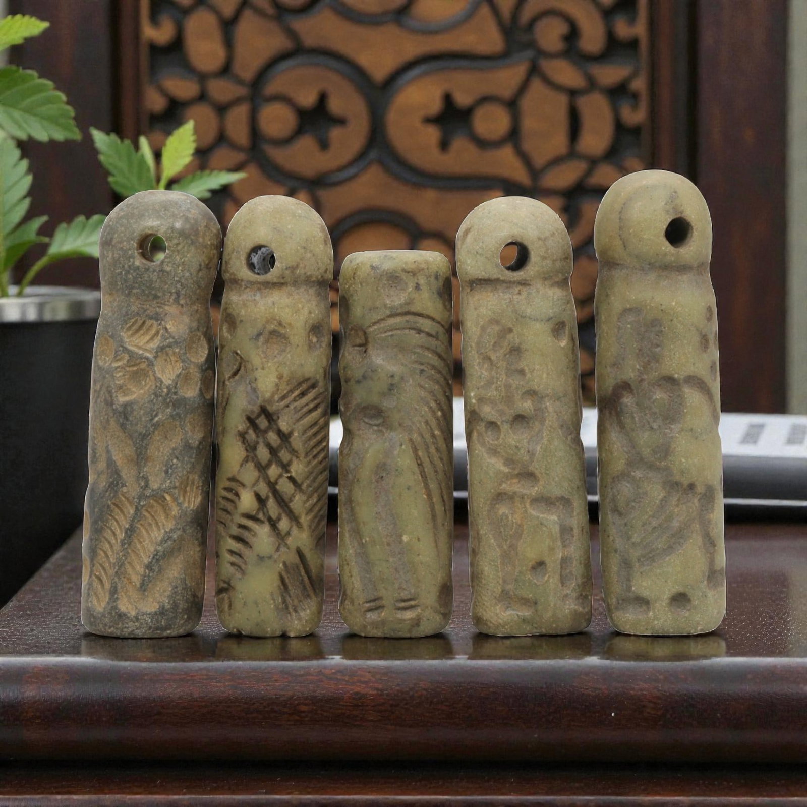A Lot of 5 Ancient Mesopotamian Serpentine Cylinder Seals, 44WP: A curated lot of five ancient Mesopotamian-style cylinder seals, carved from serpentine stone with natural patination and wear consistent with age. Each seal features a cylindrical form, most with dom