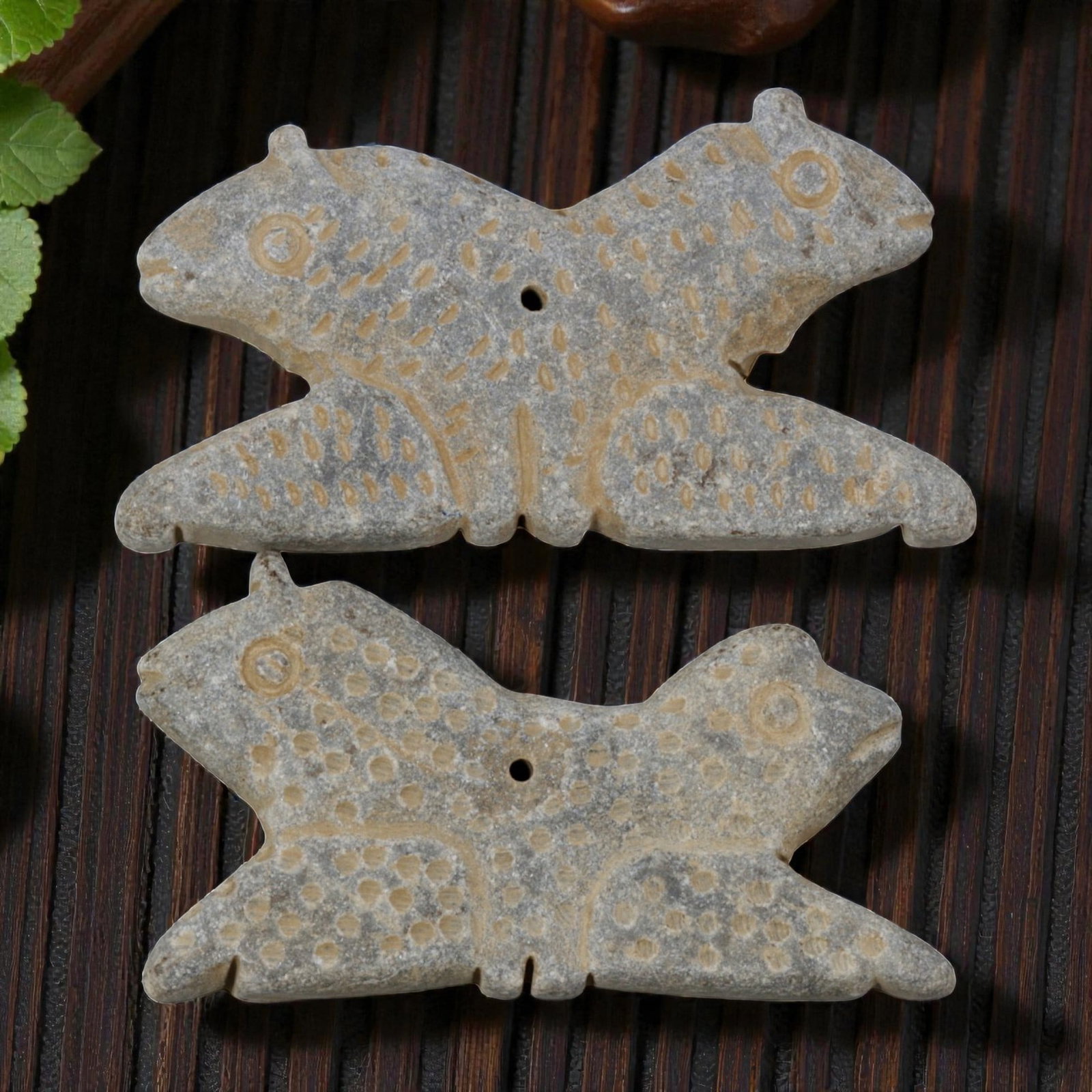 Lot of 2 Ancient Near Eastern Style Double-Headed Zoomorphic Stone Amulets, 99WM: A curated lot of two matching ancient Near Eastern-style stone amulets, each carved in the form of a symmetrical double-headed quadruped. The pieces feature incised dot patterns across their surfaces,