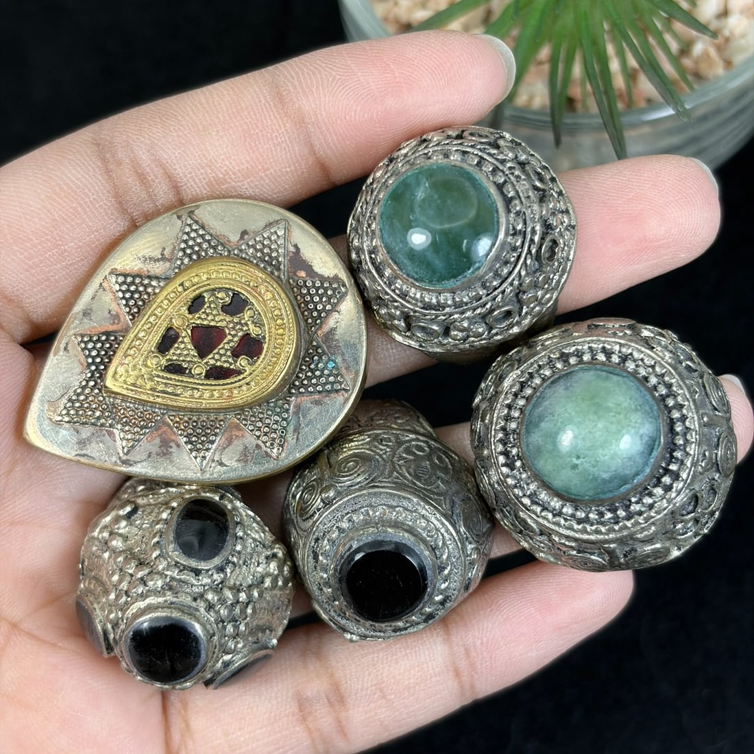 Vintage Tibetan Silvered Gilt Mixed Stone Inlay Rings Lot, 24AS: This five-piece set features untested silvered alloy adjustable rings crafted in traditional Himalayan Tibetan tribal style, showcasing varied decorative techniques including raised granulation filigr