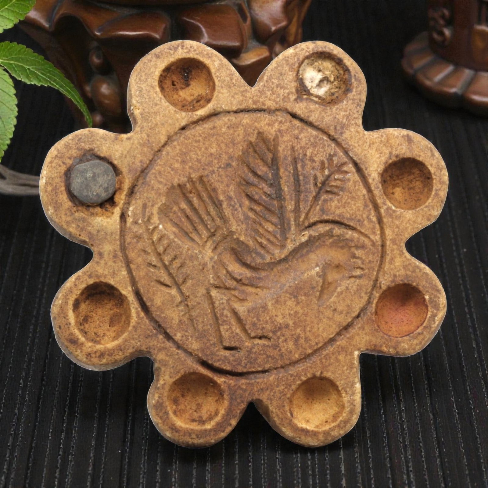 Ancient Steatite Stamp Seal - Near Eastern Bird Motif, 81ZP: This lobed stamp seal is carved from steatite, featuring a central medallion incised with a striding bird motif, detailed with feathered wings and a stylized beak, surrounded by eight evenly spaced ci