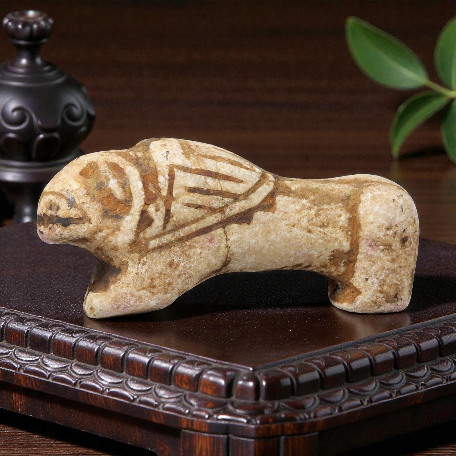 Ancient Stone Feline Figurine - Near Eastern Animal Amulet, 68BF: Carved from a light-colored stone with a naturally weathered surface, this figurine depicts a stylized feline in a crouched, forward-facing posture. The animal's form is rendered with simplified, robu