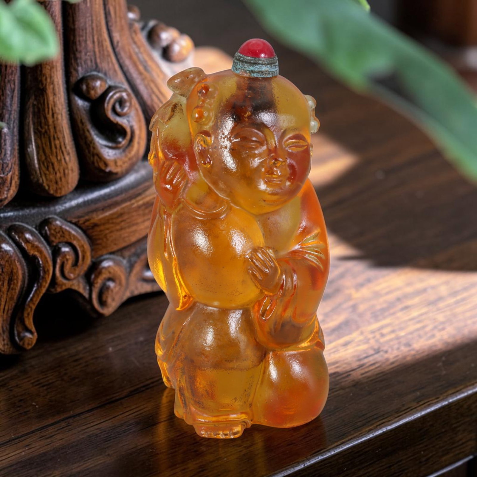 Vintage Chinese Honey Amber Liuli Glass Snuff Bottle - Kneeling Child Holding Longevity Peach, 54AS: This fully sculpted anthropomorphic snuff bottle is crafted from translucent frosted honey-amber vintage Chinese liuli glass, shaped as a plump kneeling traditional Chinese child figure with delicate 