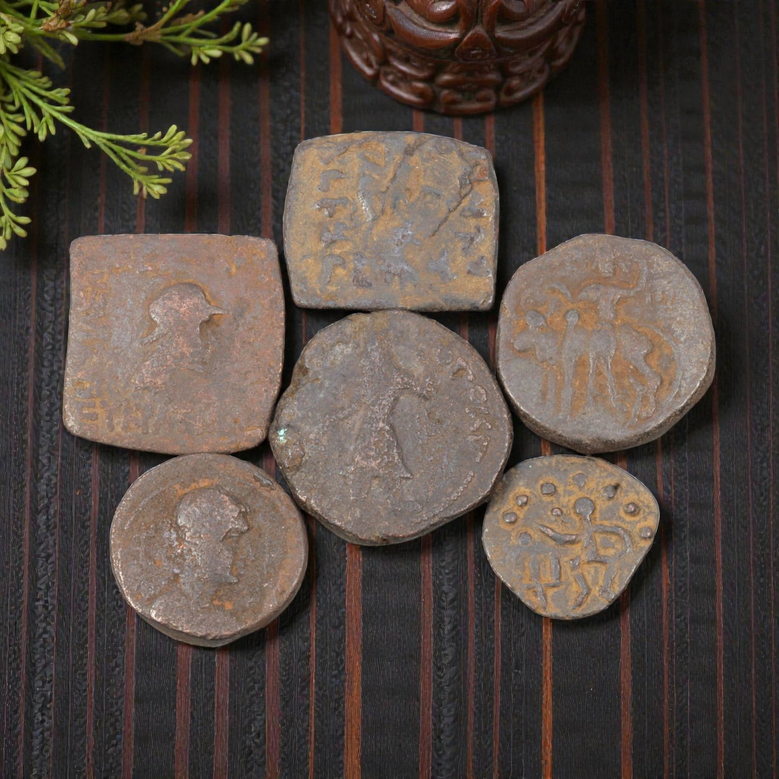 Lot of 6 Ancient Indo-Greek Bronze Coins, Circa 2nd-1st Century BCE, 15WL: The group comprises six bronze coins of varying shapes, including square, round, and irregular forms, typical of Indo-Greek coinage. The obverses and reverses depict a range of iconography, including 